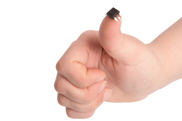 Close-up view of young girl hand holding transistor based microchip and gesturing with it, taken on...