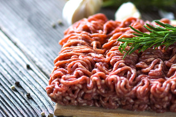 Minced Meat on  wooden background