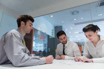 young couple signing contract documents on partners back