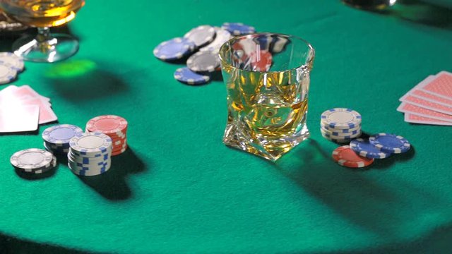 Rotating table with poker cards whiskey and cigar

