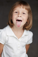 Portrait of cute little girl in a white shirt.