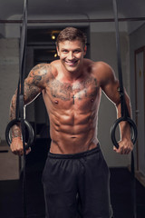 Fototapeta na wymiar Smiling tattooed muscular man.