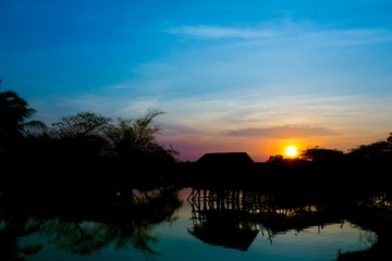 Fototapeta premium Silhouettes of Old cottage in the lake.