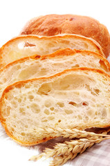 Fresh baguette bread and ripe ears of wheat