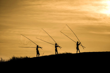Fototapeta na wymiar Silhouette of fishermen