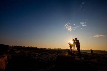 Silhouette of a young photographer during the sunset,sunrise
