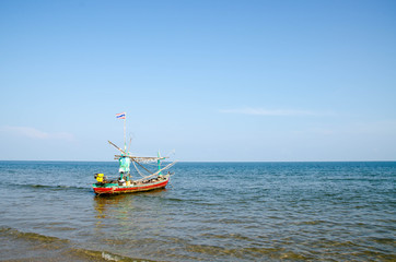 Fototapeta premium old wooden local fishing boat on on sea coast and beach with sum
