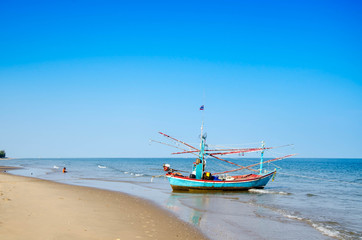 old wooden local fishing boat on on sea coast and beach with sum