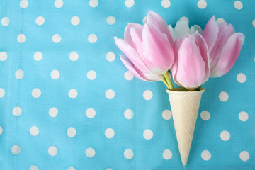 tulips pink and white in a waffle cone on the background fabric polka dot