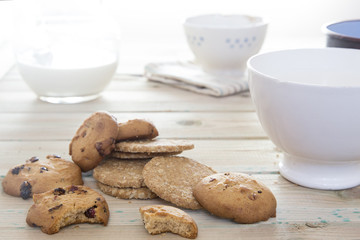 Cookies to breakfast. Good morning with biscuits and milk on a wooden table