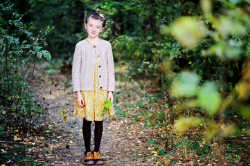 Portrait of cute child girl i in autumn park