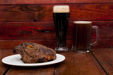 steak and beer on a wooden background