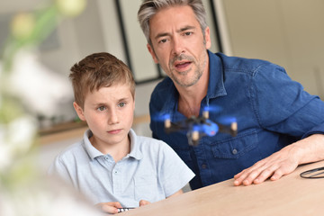 Dad and son playing with toy drone