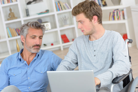 men in front of a laptop