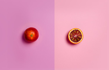 red orange on a pink background from above.Fashion color