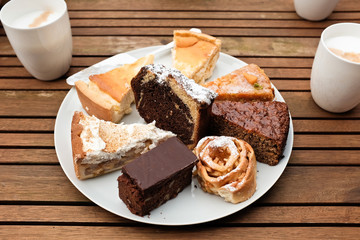 different, homemade cakes on a wooden table