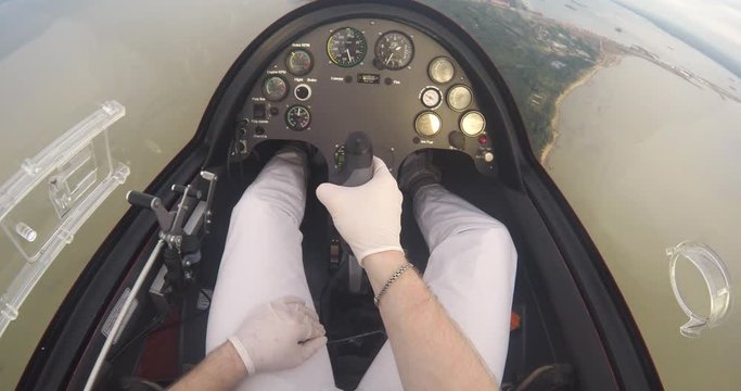 Pilot sitting in the autogyro and flight control in the sky