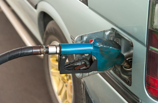 transportation and ownership concept - pumping gasoline fuel in