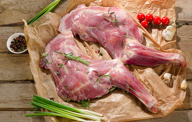 Raw lamb shanks ready for frying on  rustic wooden board.