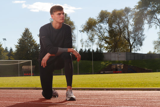 Portrait of sexy muscle man posing on stadium