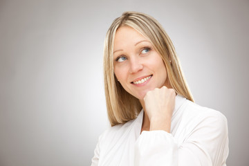 european caucasian blonde happy thinking  business woman studio portrait