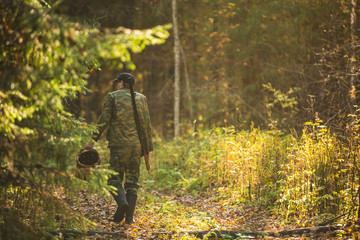 man in the woods mushrooms and berries, weapons hunter