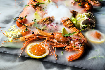 Obraz na płótnie Canvas shrimps on stone plate