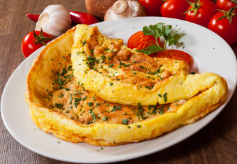 omelet in a plate on wooden table