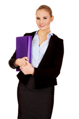 Smiling business woman holding a binder