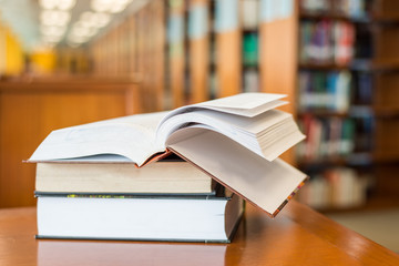 Book on the desk against books