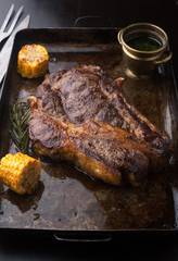Grilled Black Angus Steak Ribeye  with rosemary and corn on iron