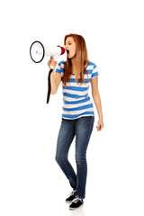 Teenage woman screaming through megaphone