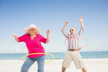 Senior couple doing hula hoop