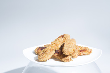 Plate of Chicken Fingers, Fried Frozen Food at Home