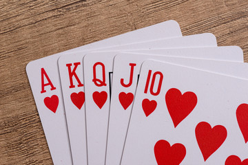 Hearts suit playing cards on wooden desk