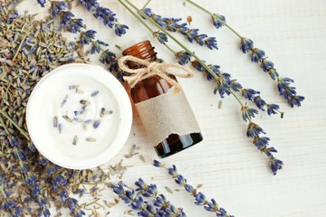 Obraz na płótnie Canvas Lavender aroma oil, herbal face cream, dried lavender sprigs.