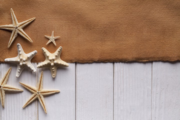 Fototapeta na wymiar Blank handmade paper sheet and starfish on wooden background