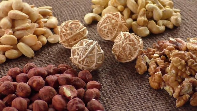 Almonds, cashew, walnuts and hazelnuts lying on burlap 
