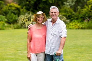 Senior couple standing at yard 