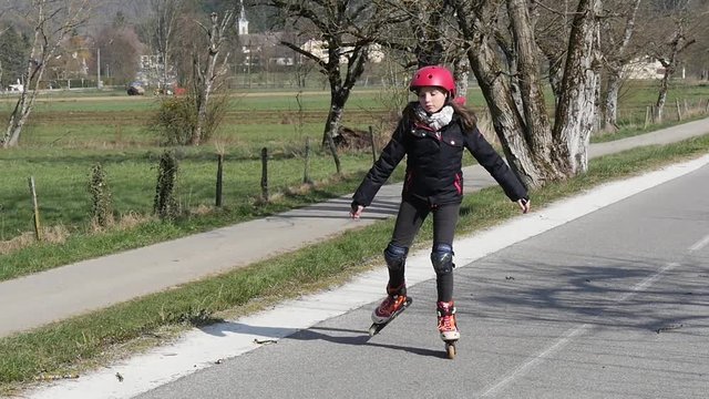 a preteen makes roller skating on a track in slow motion