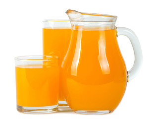 Orange juice in glasses and pitcher .