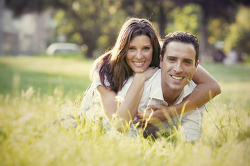 Fototapeta premium young brunette couple having fun together at the park