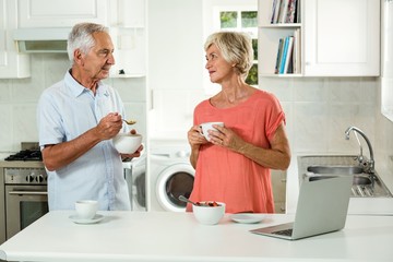 Smiling senior couple having breakfast 