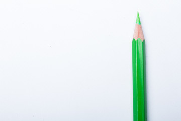 green pencil close up isolated on white