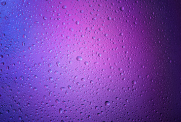 Water droplets on the glass with a Purple illumination