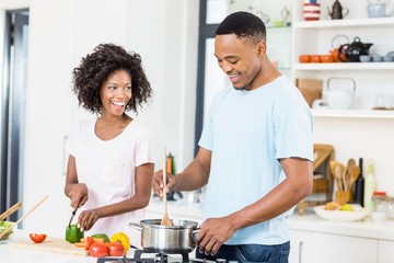 Young couple preparing a meal in kitchen
