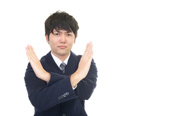 禁止の意思表示をするビジネスマン