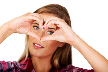 Young woman making a heart hand gesture