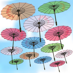 Color umbrellas decorated with flowers on sky background