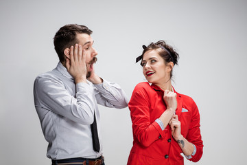 The business man and woman communicating on a gray background